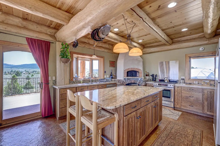 kitchen with an l-shaped countertop and an island and brown cabinets