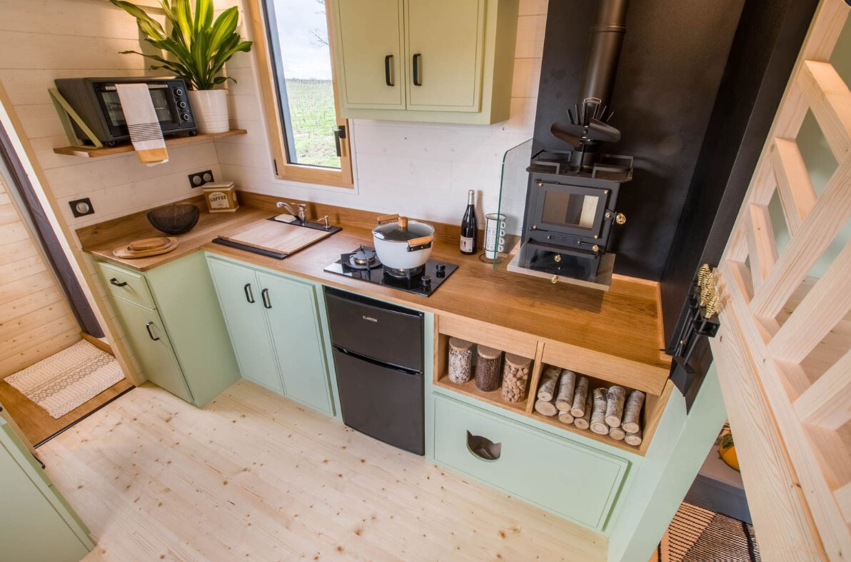 kitchen with mint cabinets and brown countertop