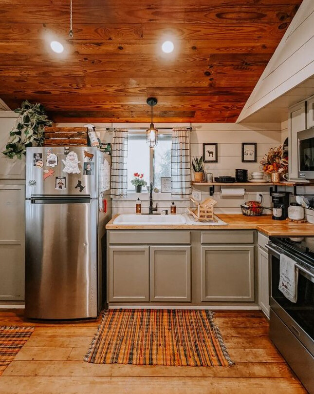 kitchen with light green cabinets and wooden countertop and wooden ceiling and walls