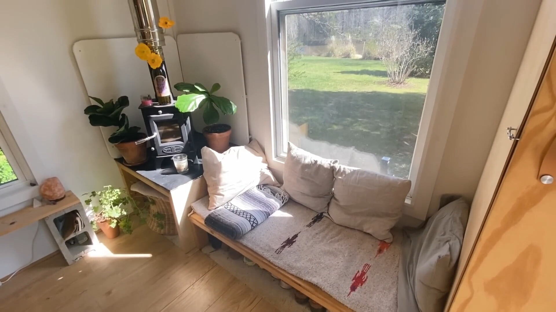 living room with a mini built-in couch and a window above it