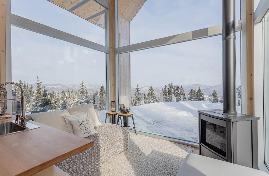 living room with floor to ceiling windows, fireplace and a cream white couch