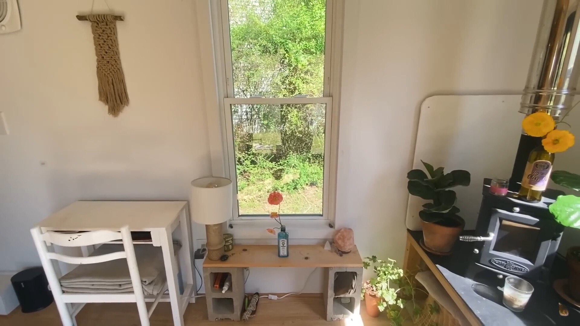 mini table with a window above and a white desk and a white chair in a minimalist living room