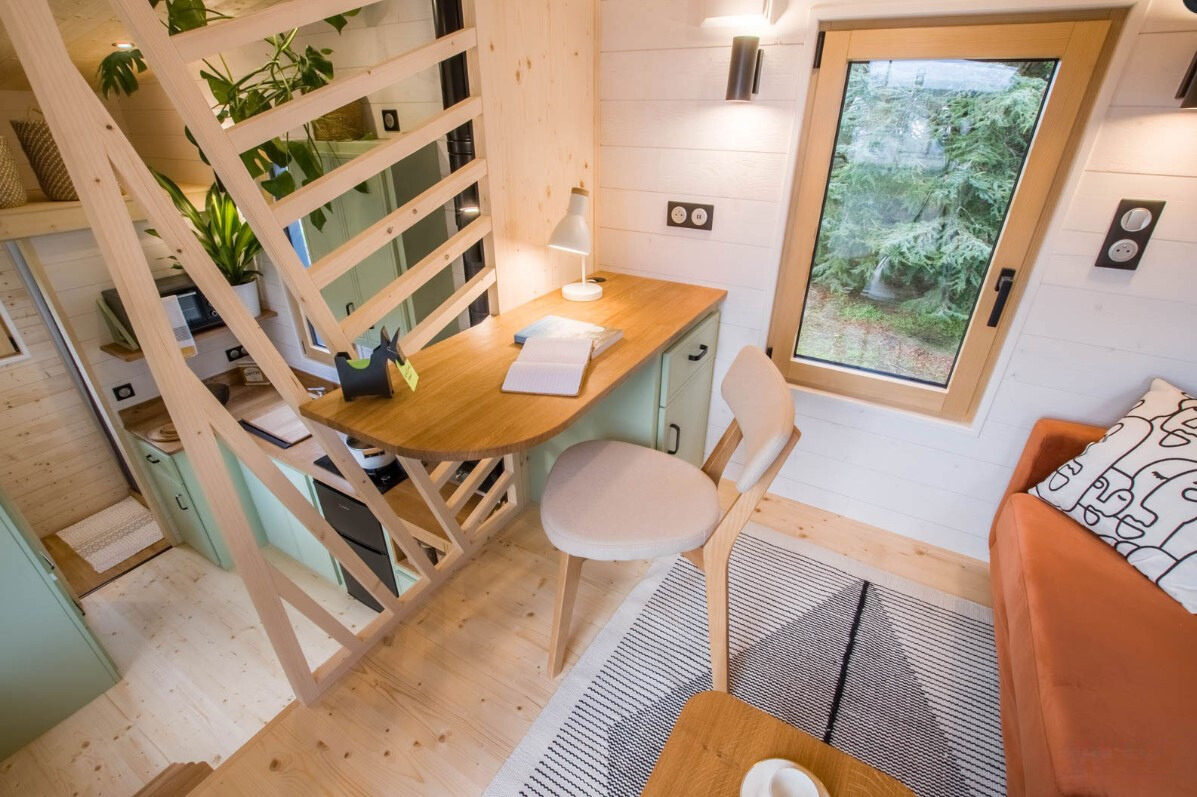 mini office area with a brown desk and mint drawers