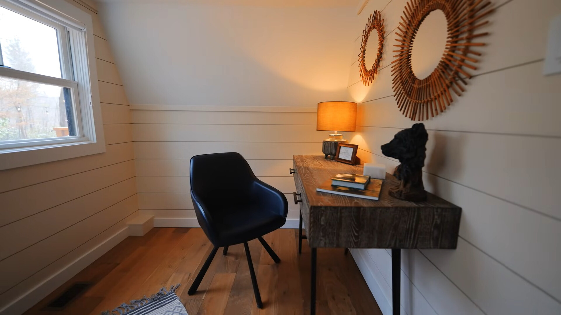 office room with a brown desk and a black chair