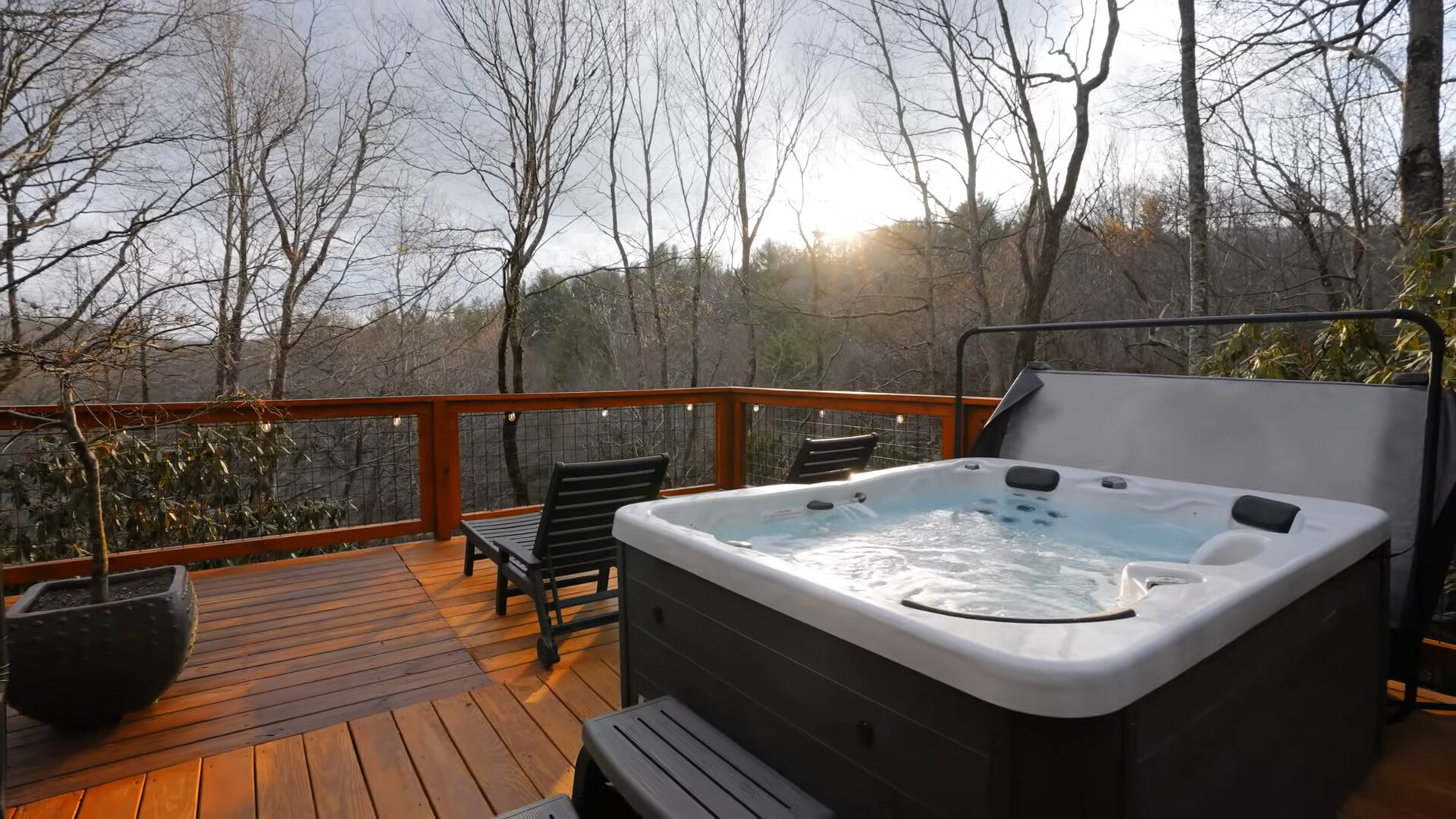 outdoors hot tub with a view of the woods from high up