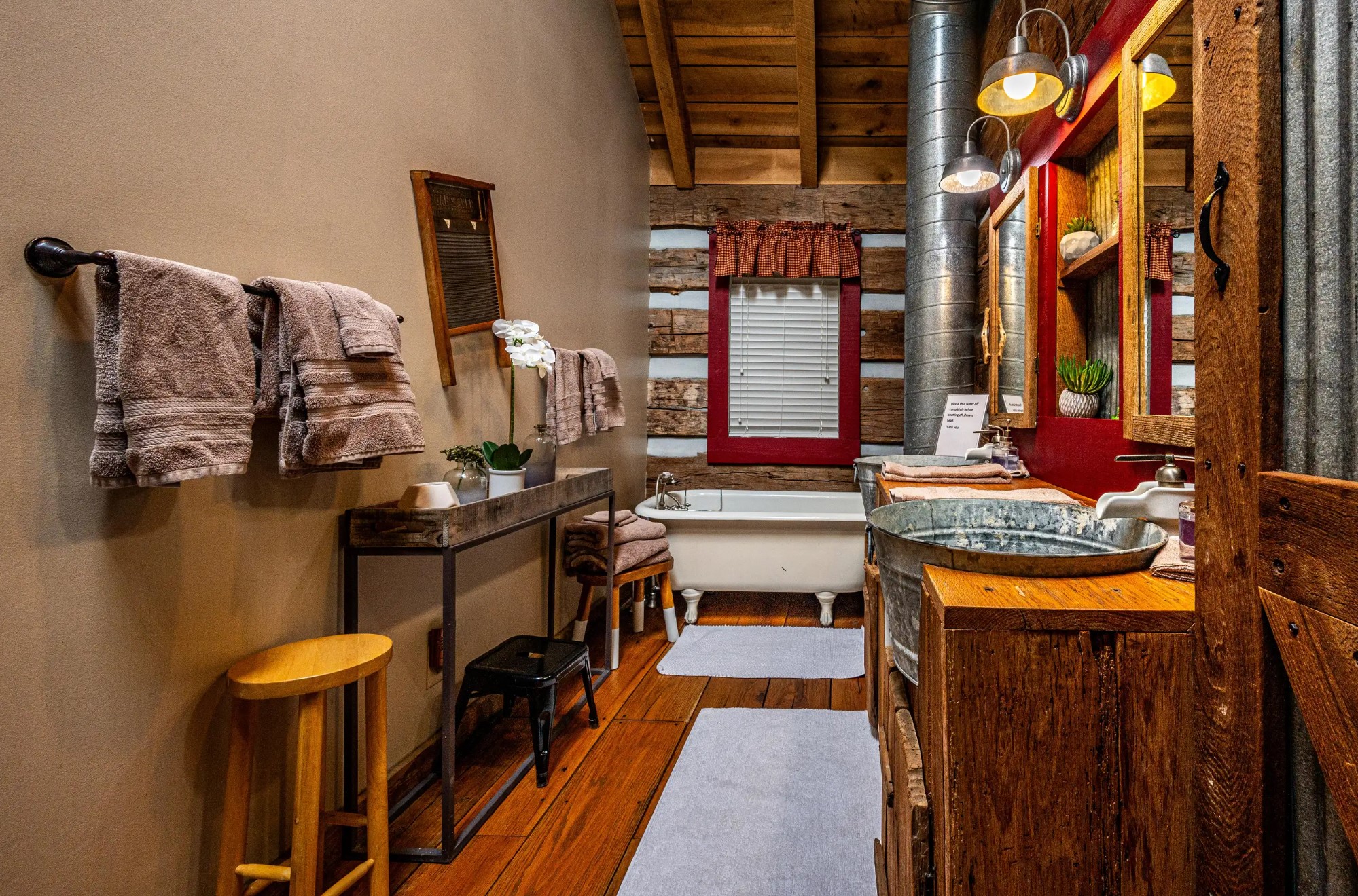 Rustic bathroom with red windows and unique vanity