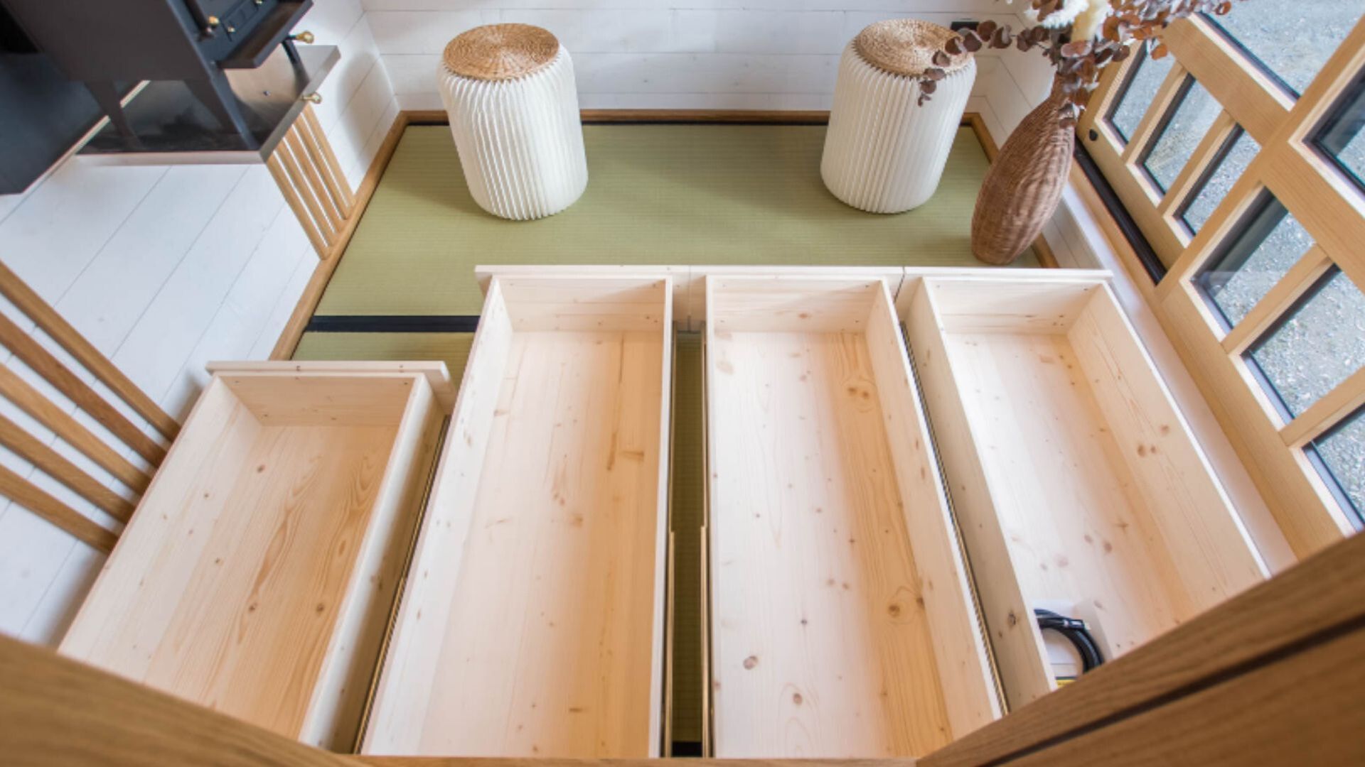 storage drawers under the elevated kitchen, taking up half the living room area