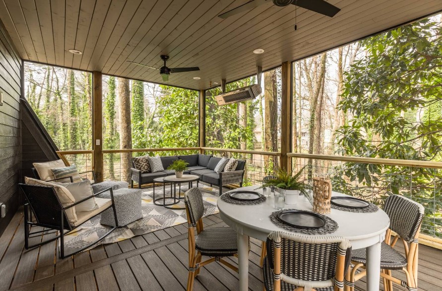 terrace with an l-shaped couch, round dining table accompanied by chairs