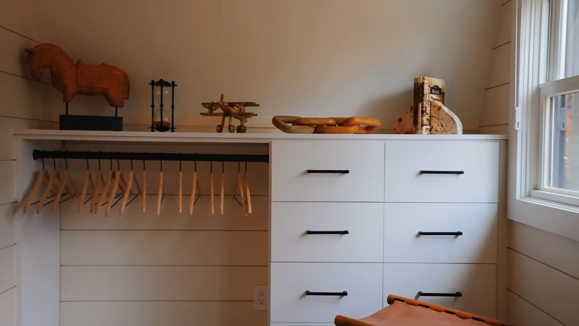 white cabinets with drawers, shelves and decor on top