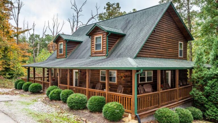 lovely log cabin with green roof