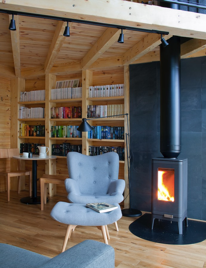 Armchair with leg rest next to fireplace