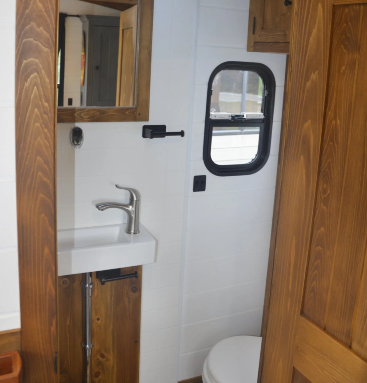 Tiny bathroom on boat with wooden details