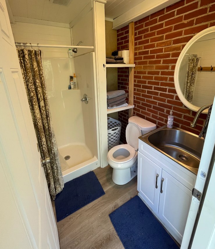 tree house bathroom with a brick wall