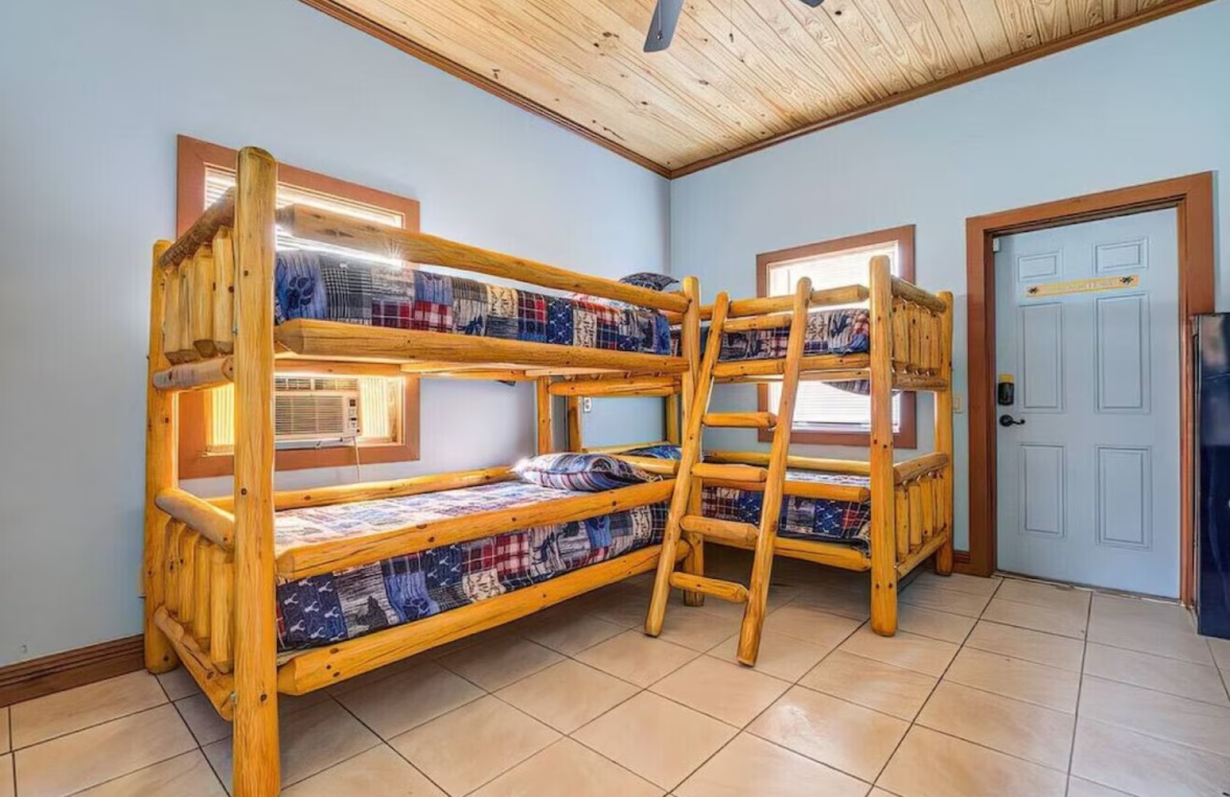 Bedroom with wooden bunkbeds with colorful bedding