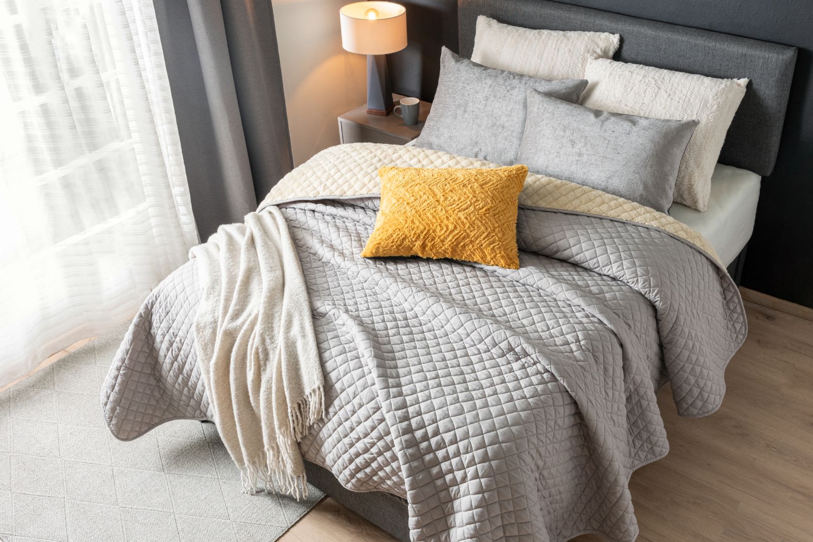 Bedroom with layered bedding and different pillows