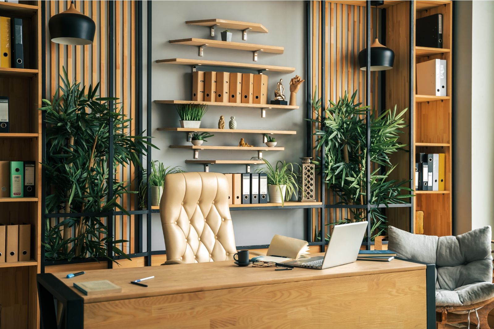 Boho home office with a leather chair and open shelves