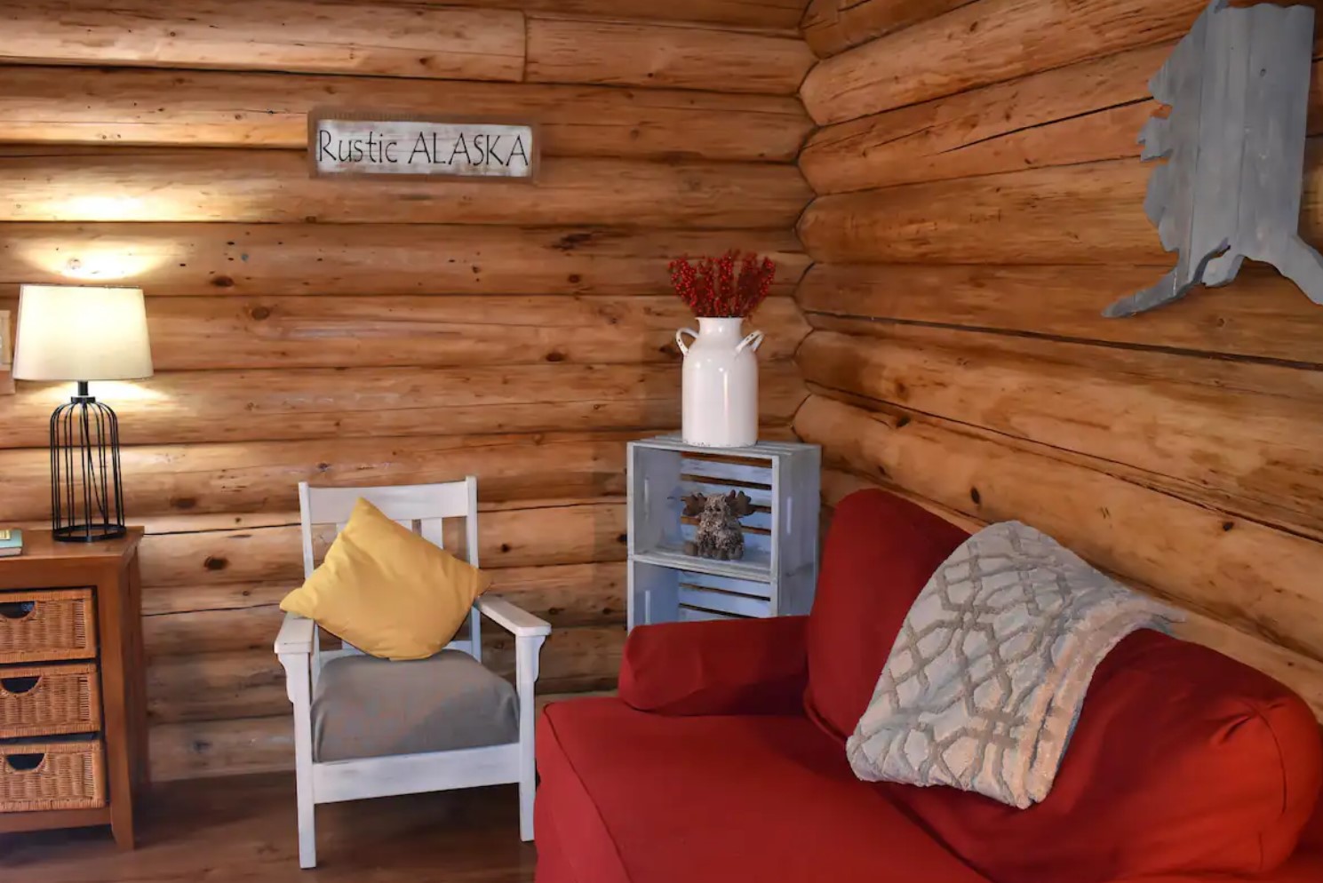 Cozy living room with a red couch and a white armchair