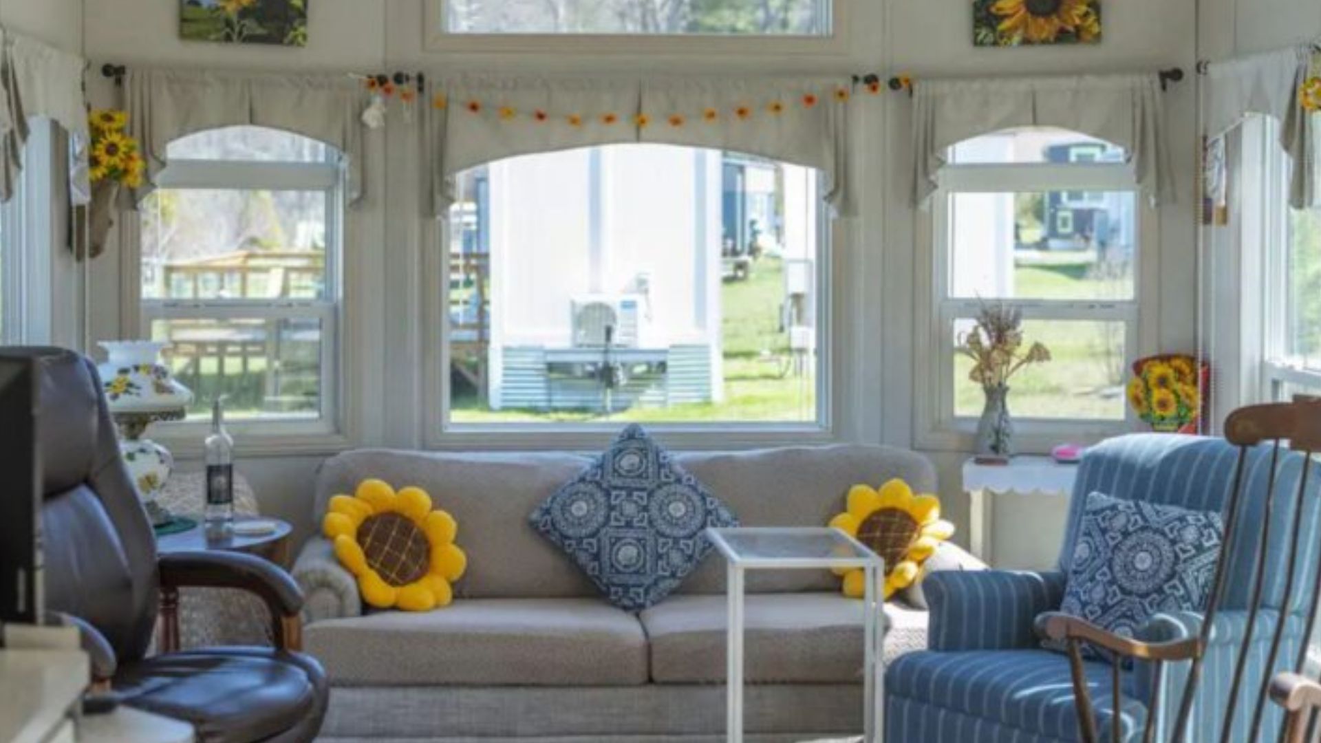 living room with lots of natural light and sunflower details all over the room