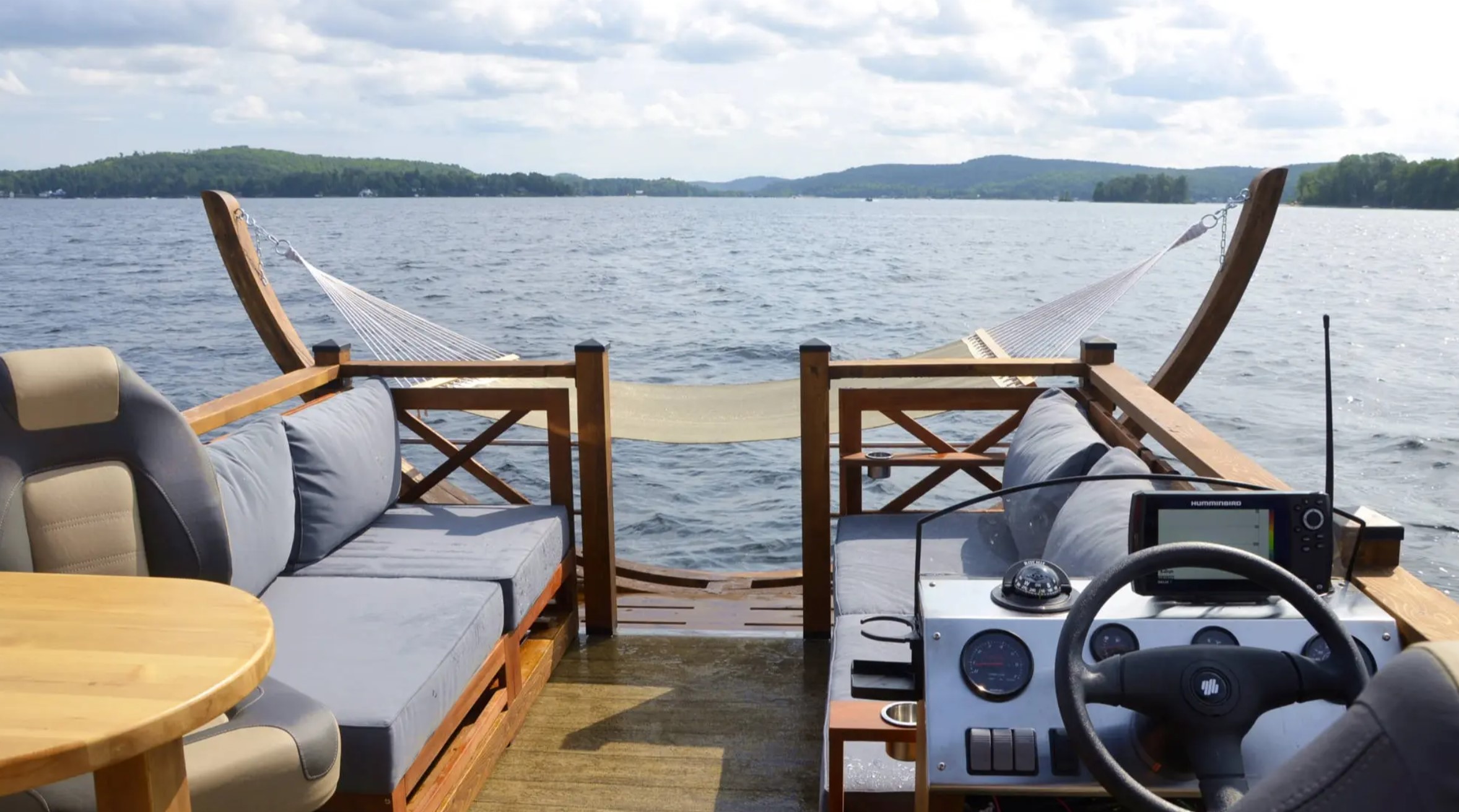 Deck of a boat home with a hammock and two couches