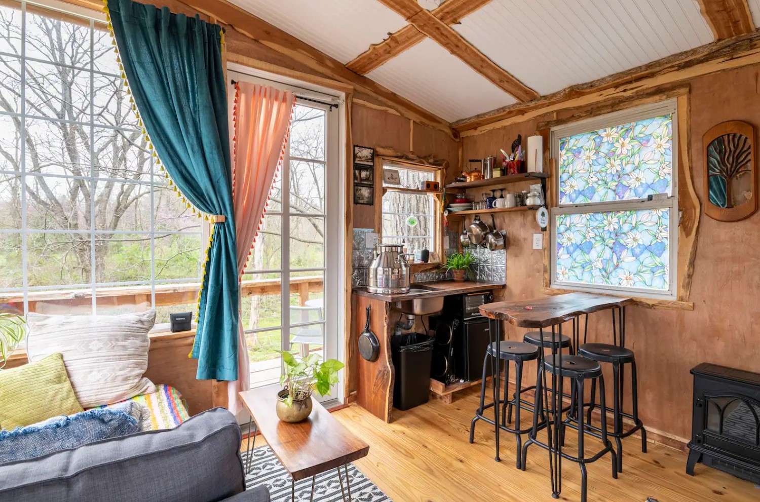 Dining area with a high table and rustic chairs and a stained window