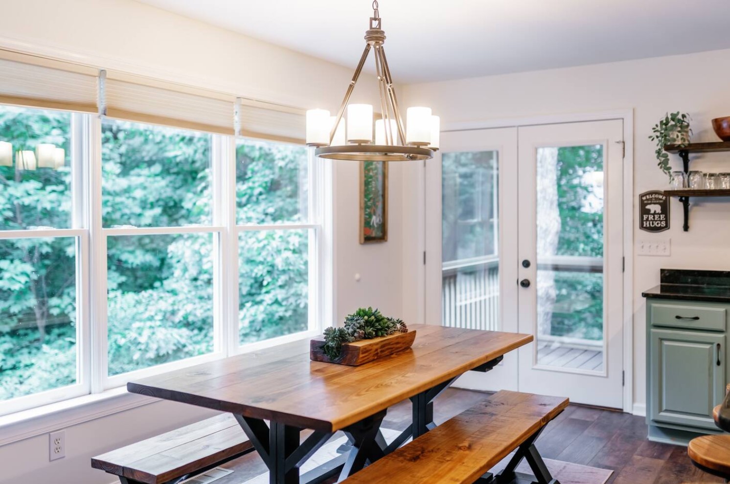 Dining room with a picnic table and large windows