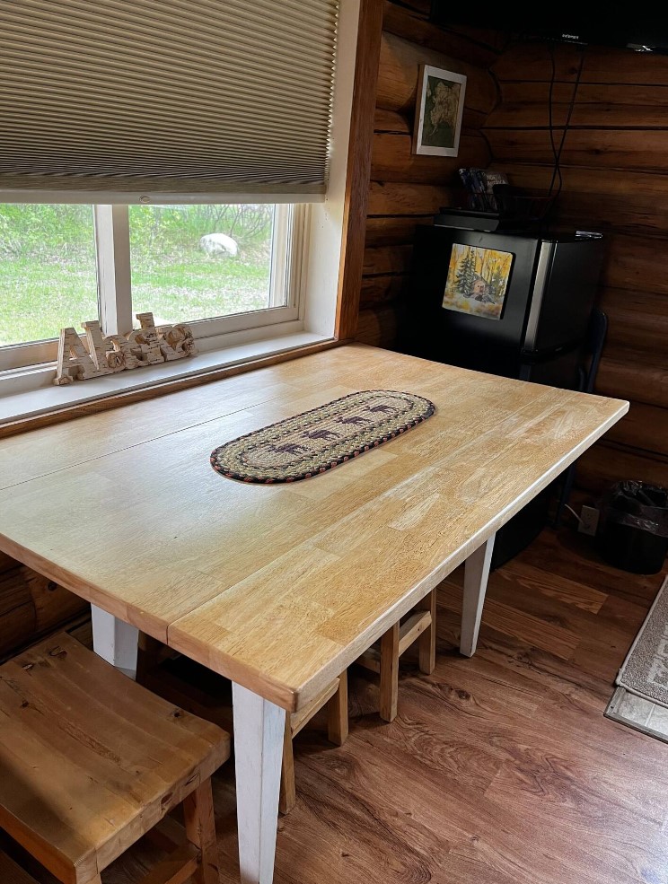 Dining room with a wooden table next to a window