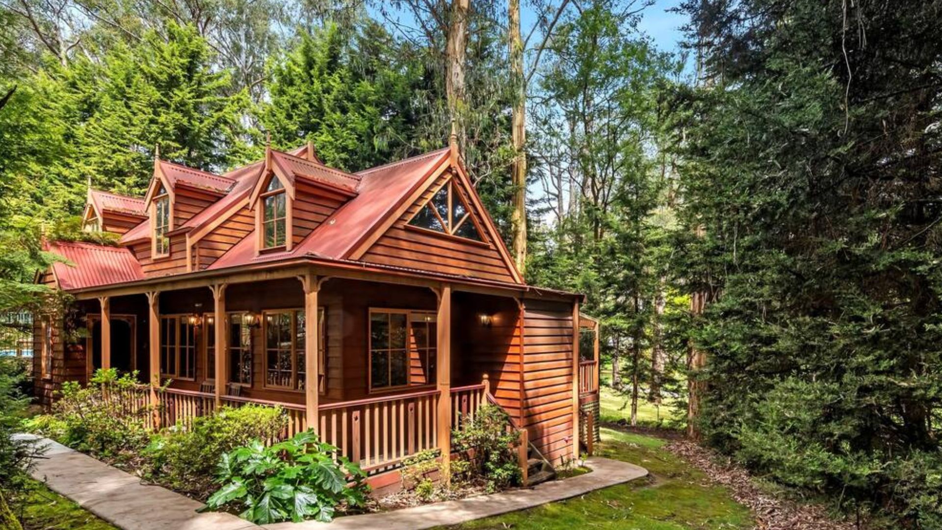 Wooden cottage in the forest, surrounded by tall trees