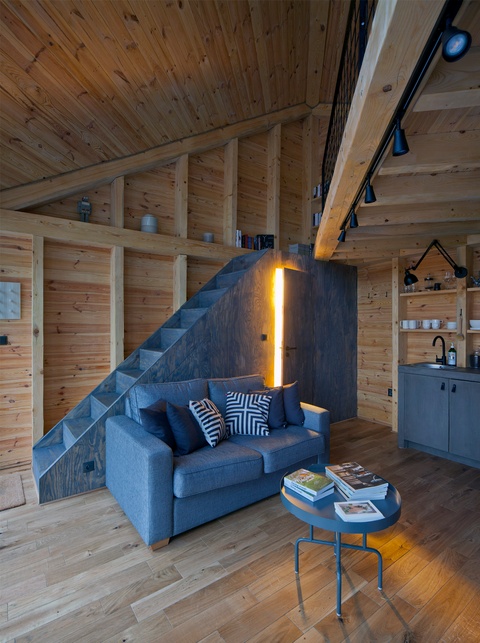 Gray comfy couch with a coffee table in a wooden living room