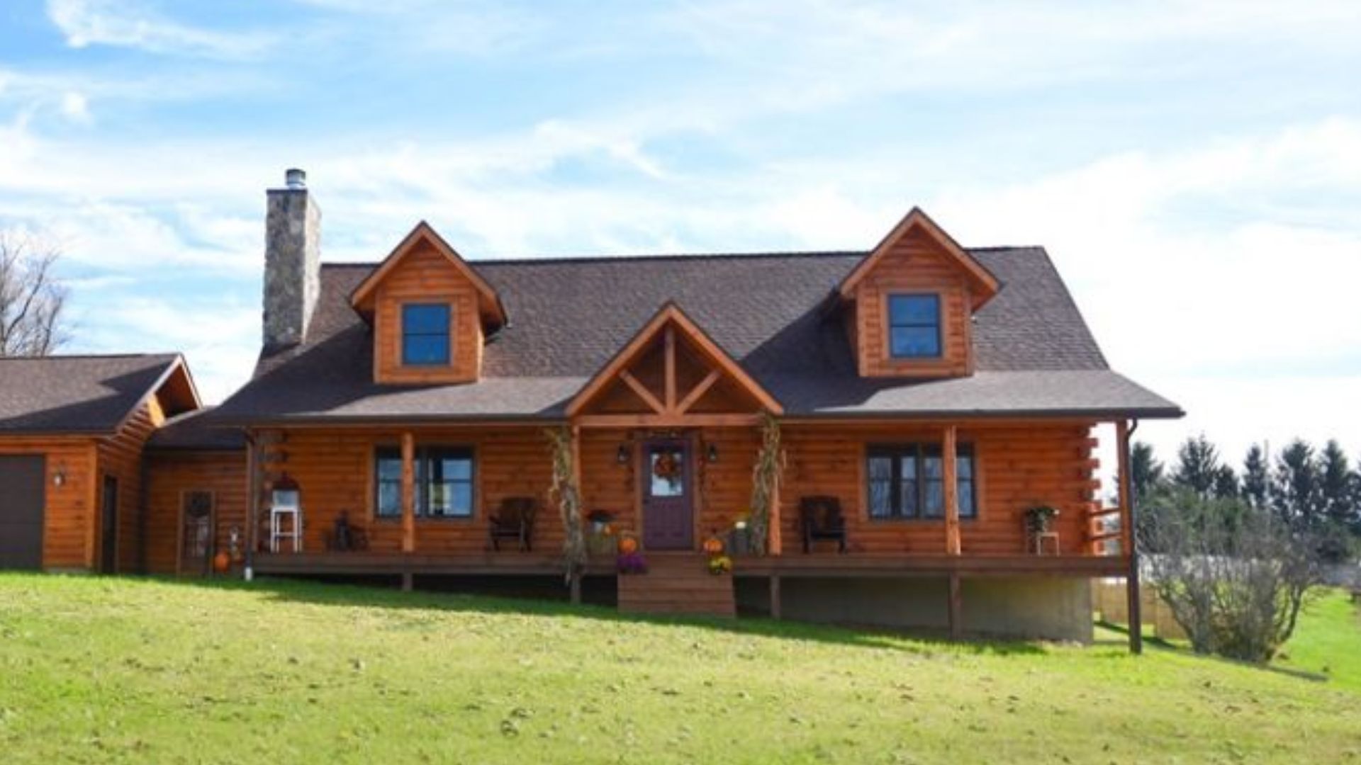 wooden house with a nice front porch, a two-car garage on the left, and a chimney on the left