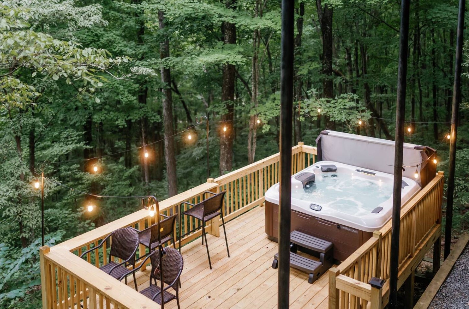 Deck with a hot tub and chairs in nature