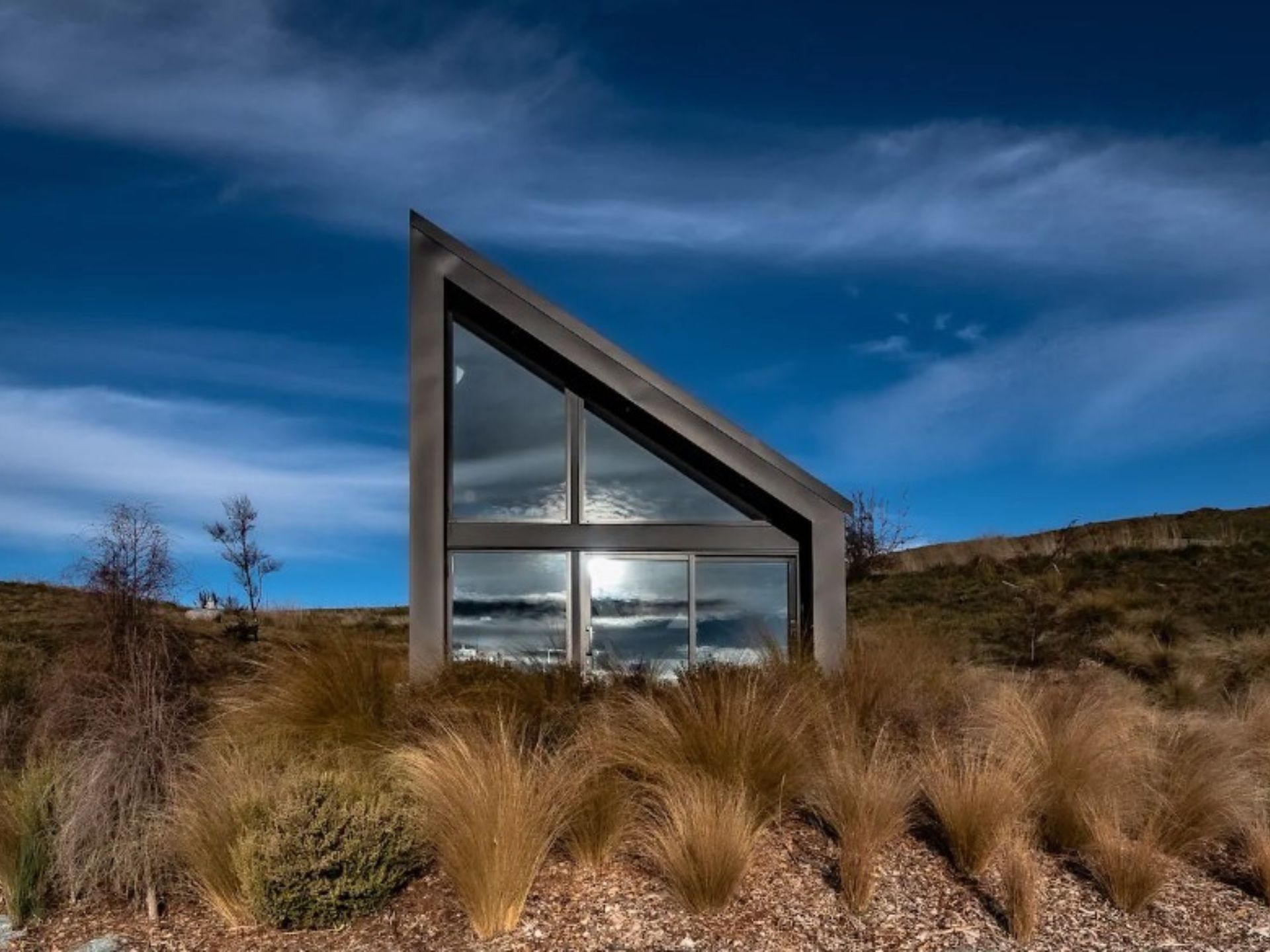 exterior of a uniquely shaped tiny home in a quiet location