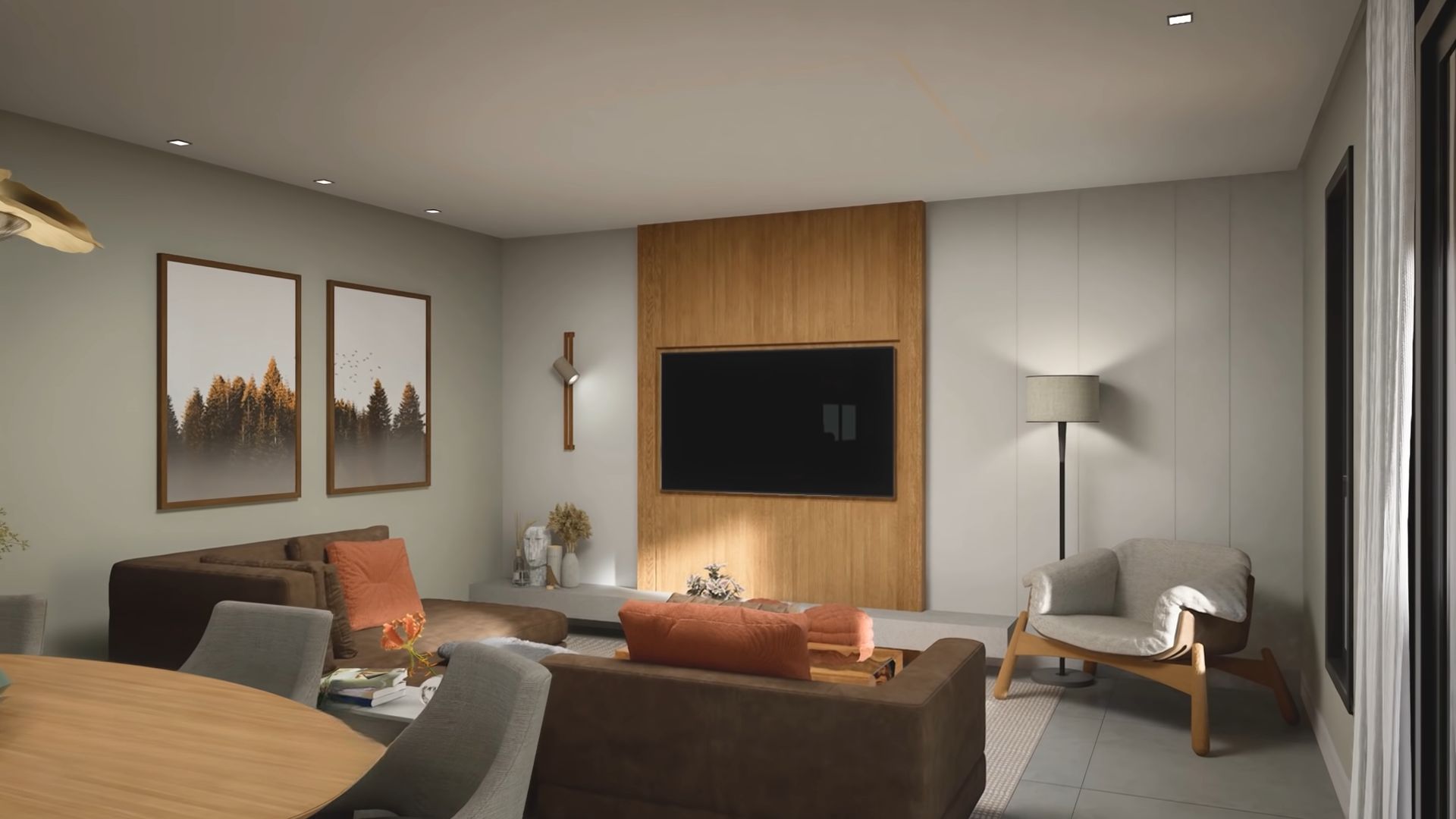 Kitchen with a brown couch with orange pillows and a TV mounted on the wall