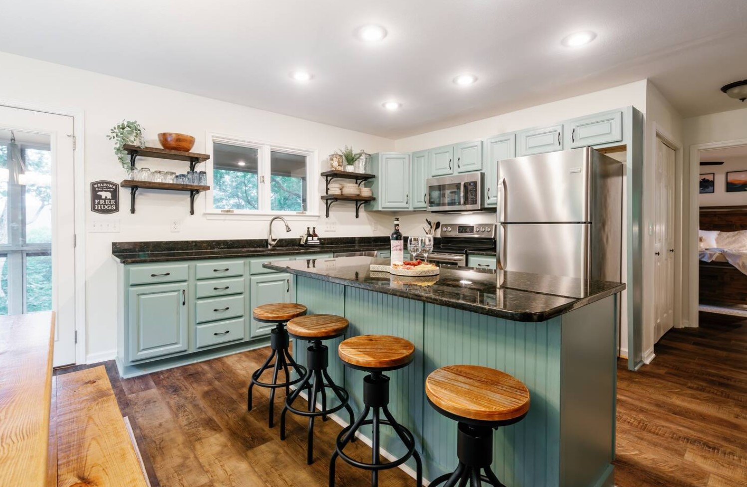 Kitchen with large green island and black details