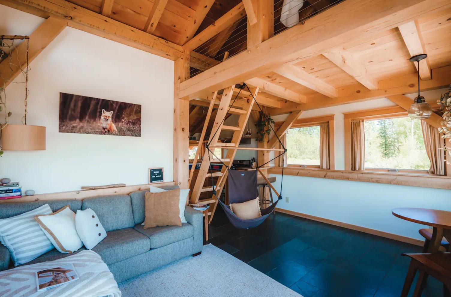 Living room with a gray couch and a swing