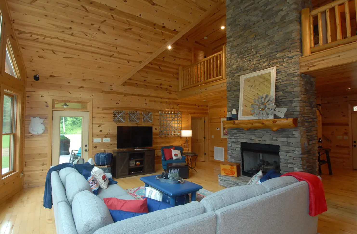 Living room with a white couch and a stone fireplace