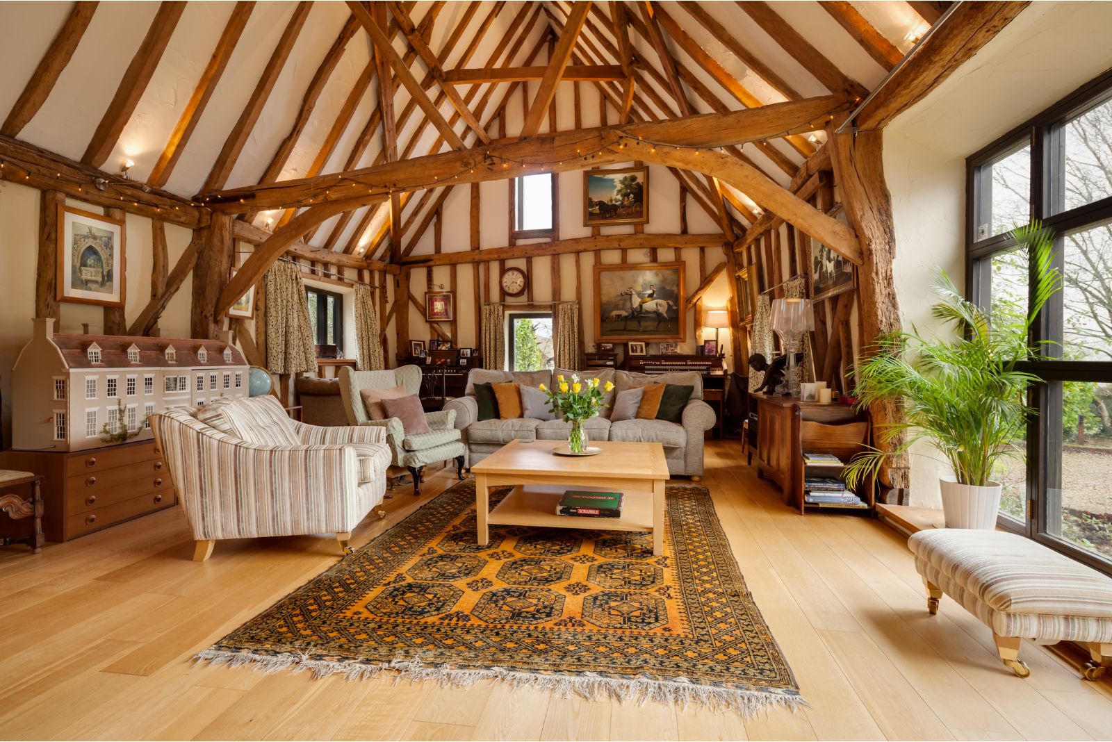 Living room with tons of wooden beams and a yellow rug