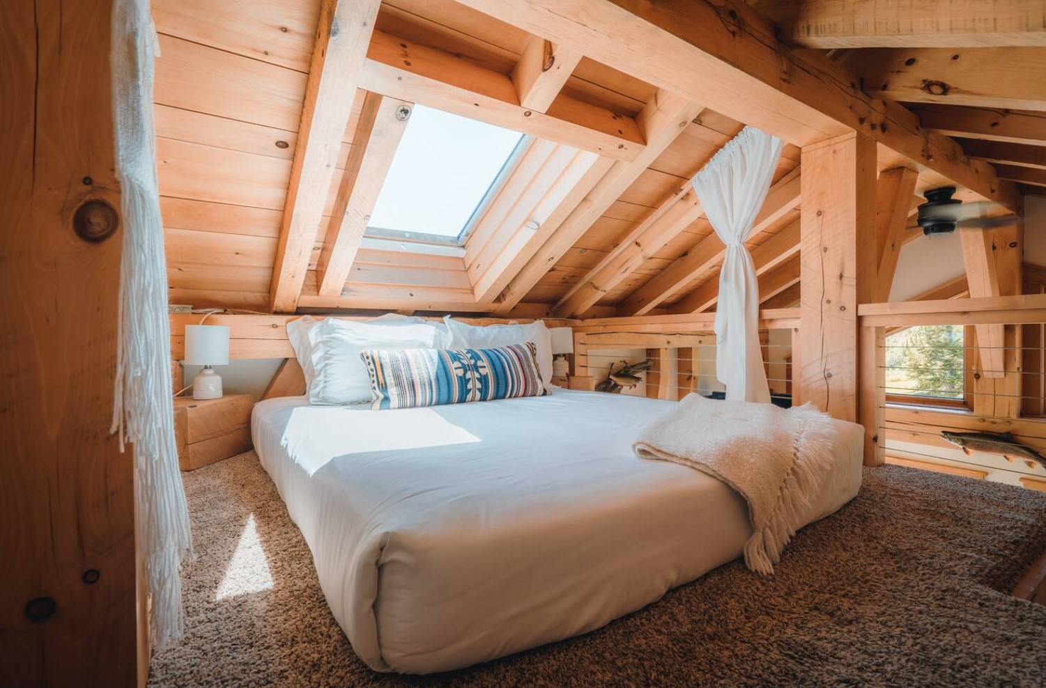 Loft bedroom with king-sized bed and skylight