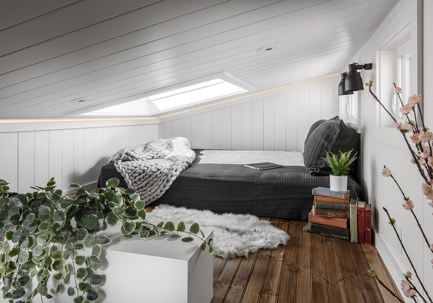 Loft bedroom with full-sized bed and a skylight