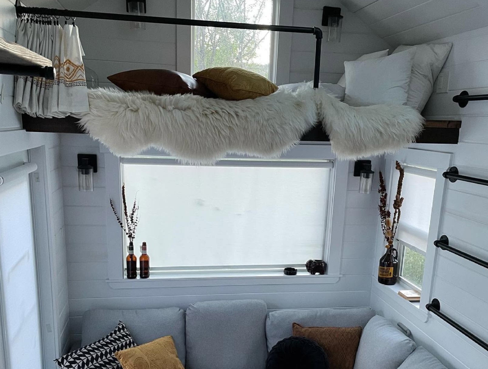 Loft in living room with a blanket and pillows