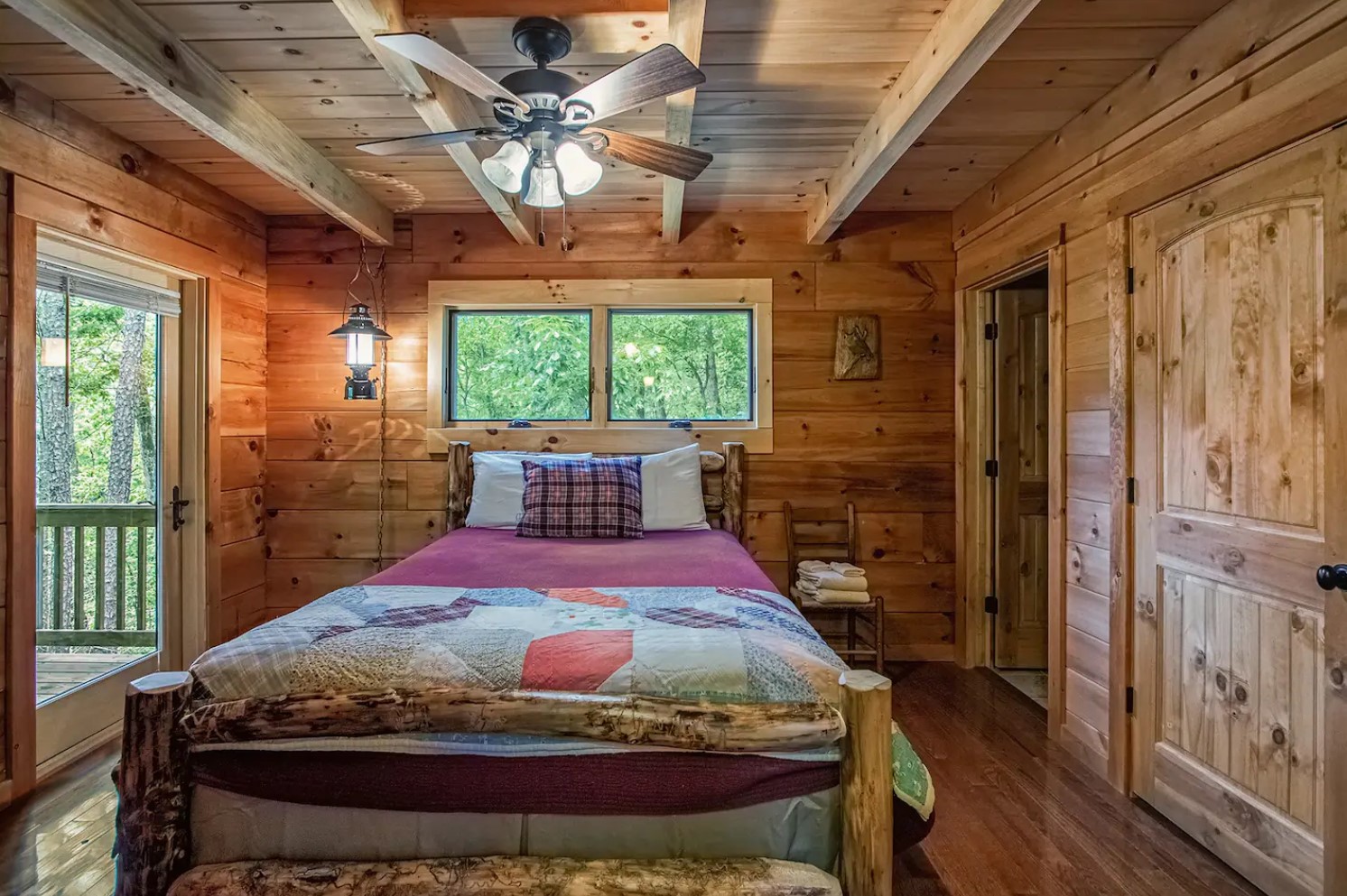 Master bedroom with a full-sized bed, ceiling fan and decorations