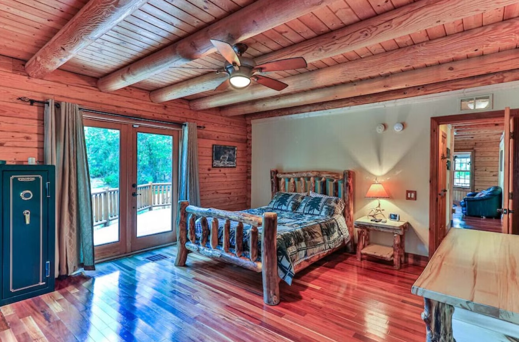 Master bedroom with a wooden bed frame and a green safe