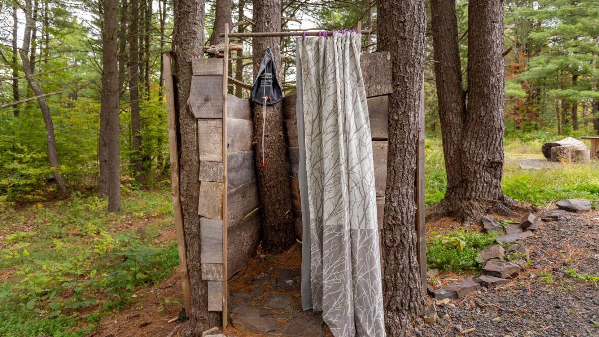 outside shower behind the curtain and the trees