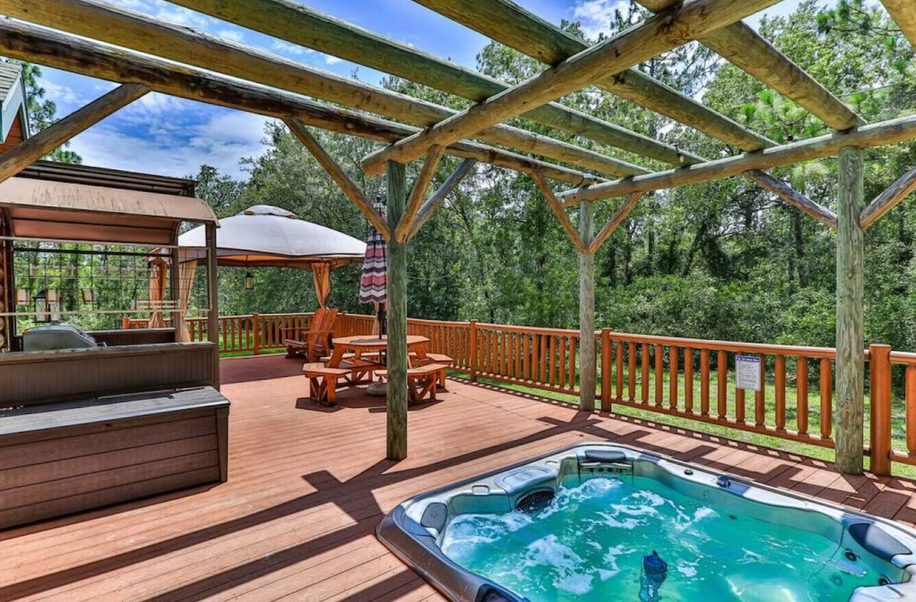 Patio with a hot tub, lounge area and a grill