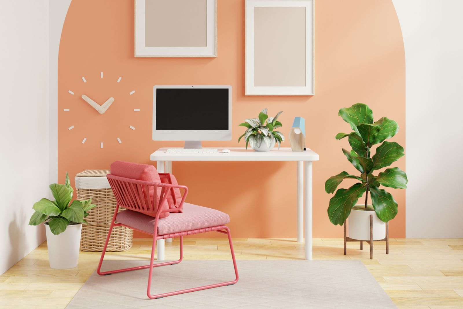 Pink home office with a pink chair, white desk and a plant