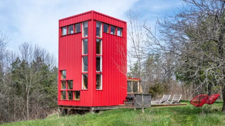 exterior of a tall red shipping container home