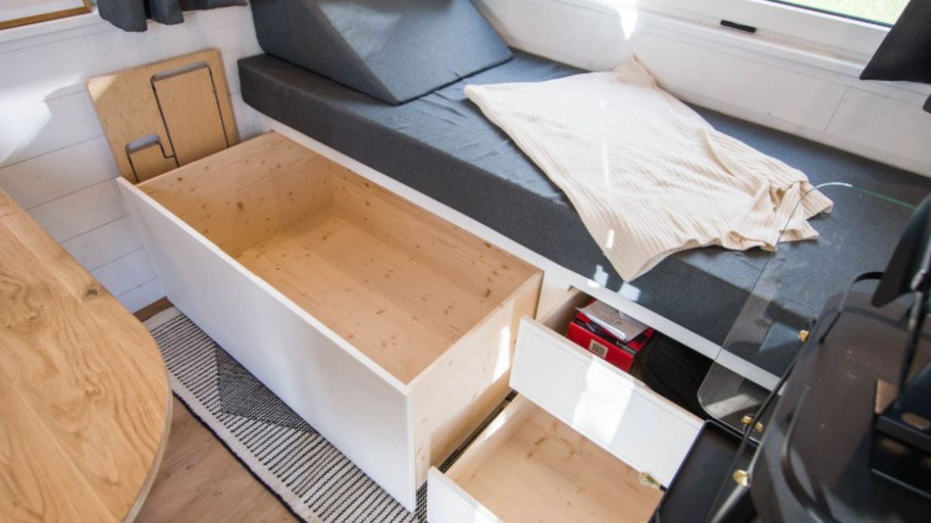 storage drawers under the sofa bed by the window