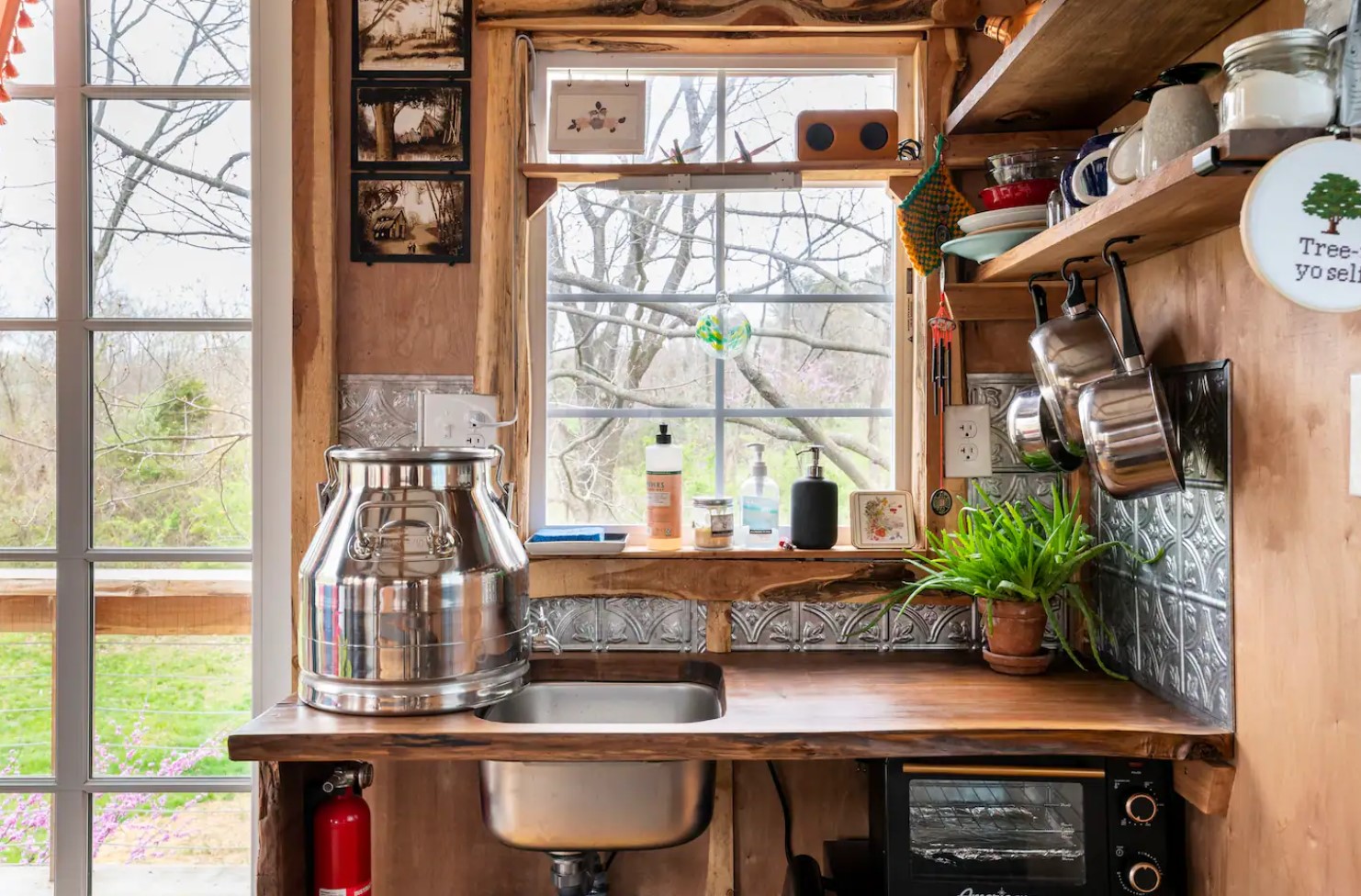 Tiny kitchenette with hanging pans and a window