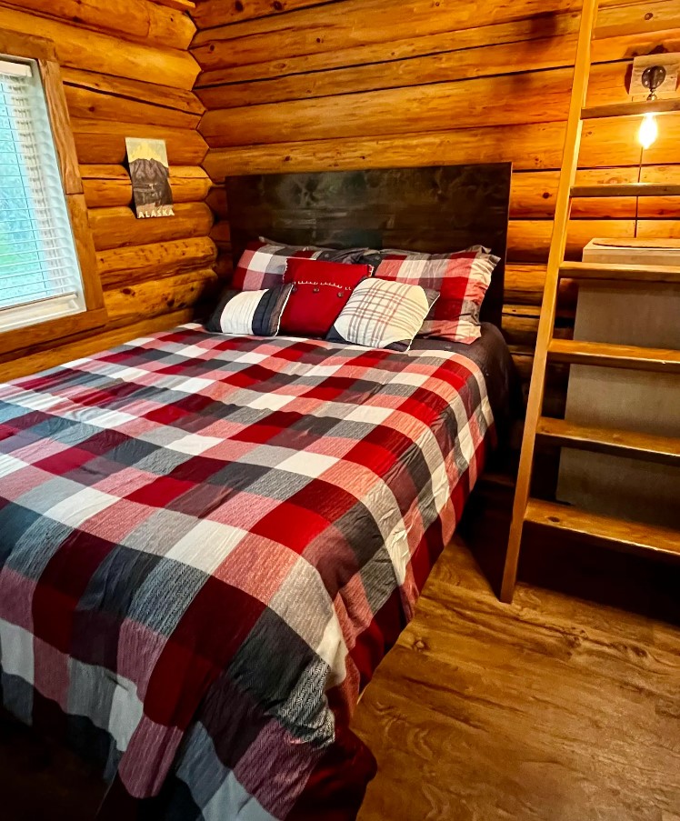 Wooden bedroom with a comfy queen-sized bed and adorable bedding