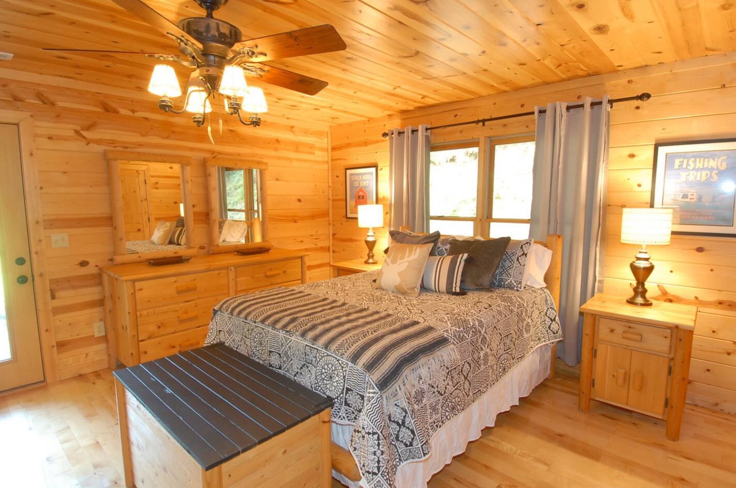 Wooden master bedroom with a queen-sized bed and a window