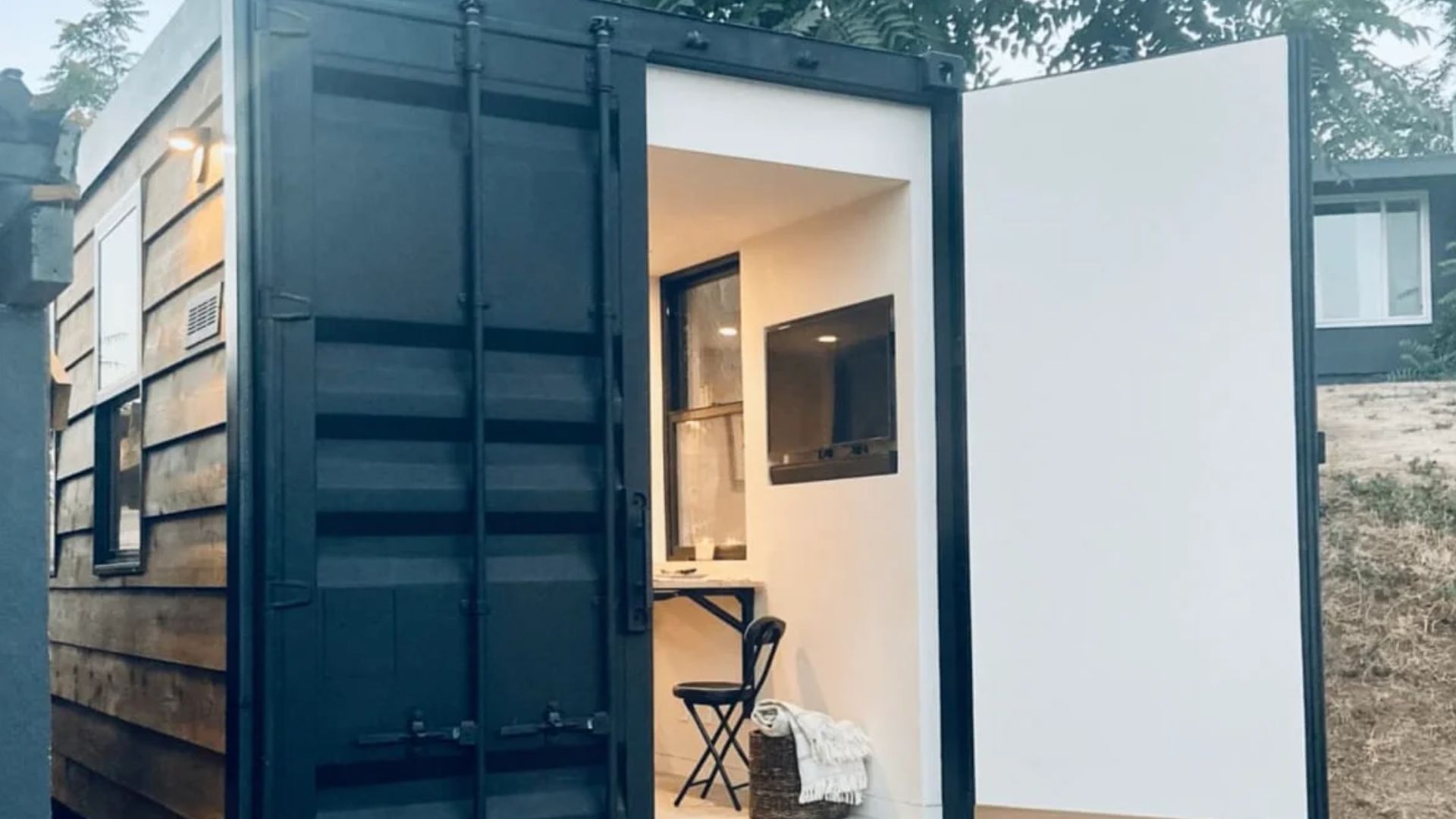 black container house with back door open